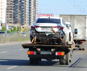 Transportation of a broken car by tow truck, Dolnevostochny Prospekt, Saint Petersburg, Russia, June 2021