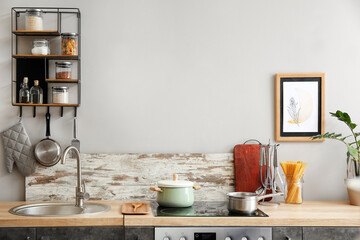 Fototapeta na wymiar Cooking pots on stove in stylish interior of modern kitchen