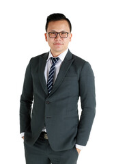 Young and handsome businessman wearing dark gray suit and eyeglasses standing with friendly face and self-confidence with hand in pocket