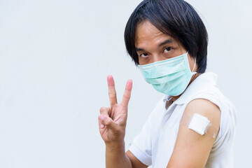 asian man wear mask and get vaccinated of covid-19 