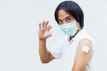 asian man wear mask and get vaccinated of covid-19 