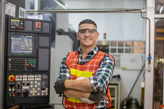 Portrait of male factory worker standing with arms crossed in drinks production factory