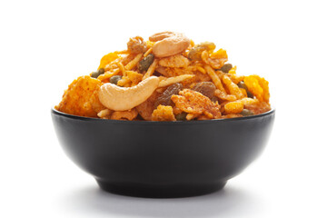 Close up of corn flex mixture Indian namkeen (snacks) on a ceramic black bowl.