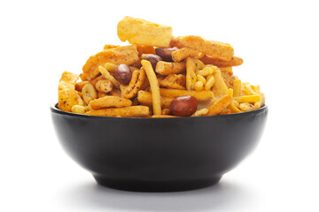 Close-Up of Indian spicy snacks (Namkeen) - (All in one) in a black Ceramic bowl, made with fried peanut, corn flakes, sweet pea, pulses, cashew nuts.