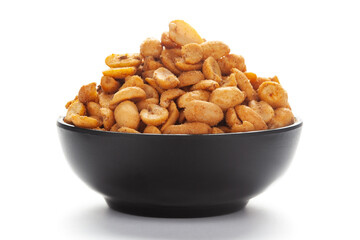 Close-up of Heeng jeera Peanuts mixture Indian namkeen (snacks) in black bowl over white background.