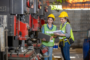 Engineer and workers Asian working using laptop computer. industrial woman engineer and worker with laptop in a factory, working.