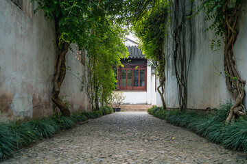 A straight alley in a Chinese garden in Suzhou, China.