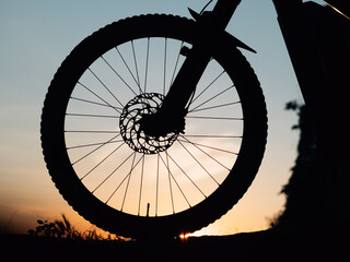 silhouette of a bicycle or ebike at sunset - 437340371