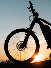 silhouette of a bicycle or ebike at sunset - 437340392