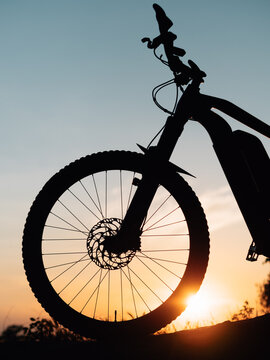 silhouette of a bicycle or ebike at sunset