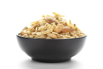Close-Up of Aloo Mixture in a black Ceramic bowl made with potatoes, peanuts, raisins. Indian spicy snacks (Namkeen), Top View