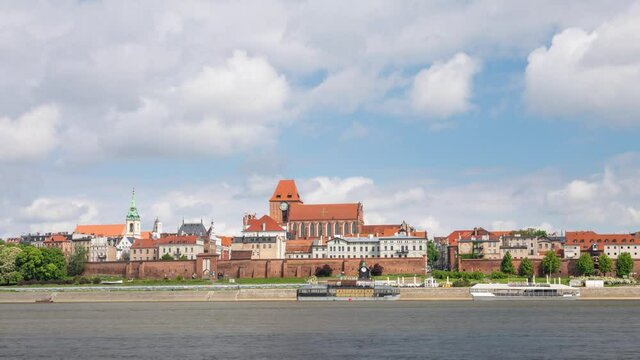 Torun, Poland. Time lapse view of city skyline from side of Vistula river
