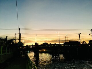 Bridge walking path cross Khlong Saen Saeb on night time, main canal transport in Bangkok, Sunset scene