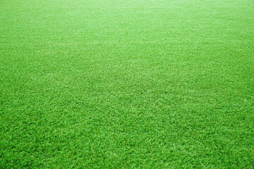 Artificial grass of football field, Green lawn for texture background, Perspective