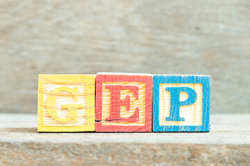 Color alphabet letter block in word GEP (abbreviation of good engineering practice) on wood...