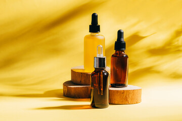 Cosmetics for face body for SPA procedures. Aromatherapy essential oil gel serum on wooden podiums...