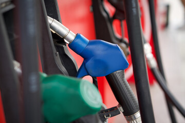 Closeup blue gas pump nozzle in gas station.