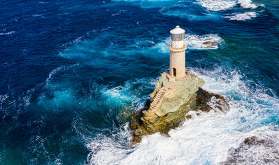 The beautiful Lighthouse Tourlitis of Chora at night. Andros island, Cyclades, Greece