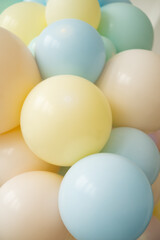 colorful pastel colored balloons. Yellow, blue, green balls close up