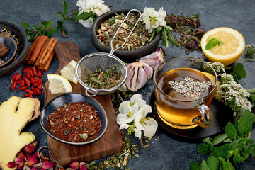 Various kinds of herbal tea on dark background. Natural herbs medicine.