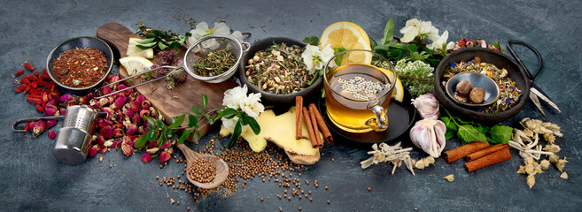 Various kinds of herbal tea on dark background. Natural herbs medicine.