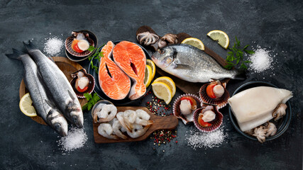 Seafood variety on dark background. Healthy diet eating concept.