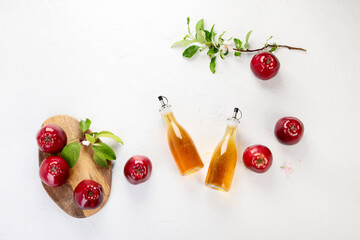 Apple cider vinegar and fresh apples on light background. Healthy organic food.