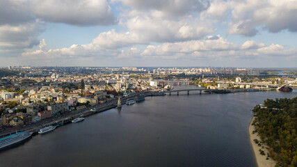 Obraz premium Aerial view of Kyiv city and Dnieper river. Podil historical district skyline from above. Panorama of the capital of Ukraine