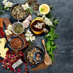 Various kinds of herbal tea on dark background. Natural herbs medicine.