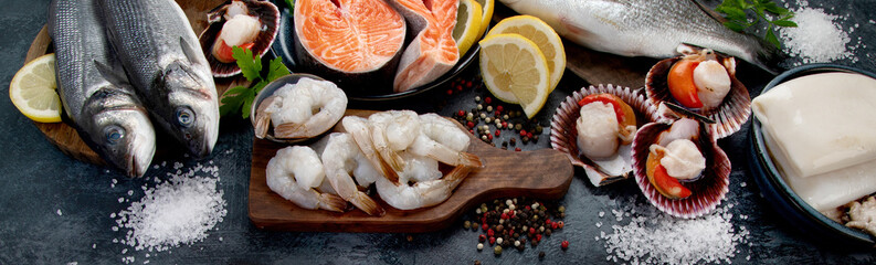 Seafood variety on dark background. Healthy diet eating concept.