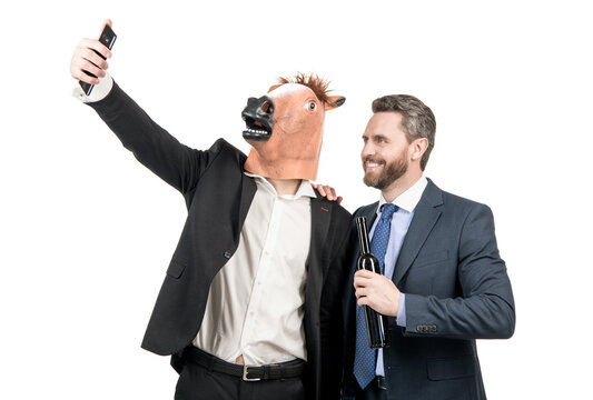 Happy professional man in horse head mask and drunk manager take self-portrait with phone, selfie