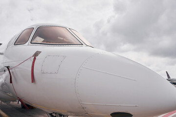 Front view. Turboprop aircraft parked on the runway at daytime