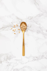 Golden spoon with natural seeds