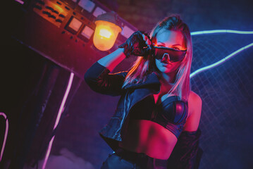 Young cyberpunk style girl in the neon lights concept.