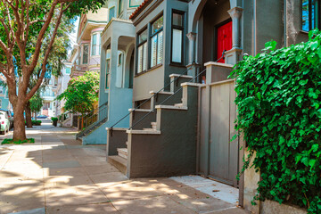 Facades of townhouses with famous Victorian architecture, streets in San Francisco