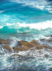 Aerial top view of beautiful sea waves and rocky coast. The concept of calmness on nature.