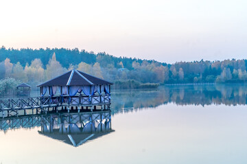 gazebo on the water. photo of a spacious gazebo in the country.