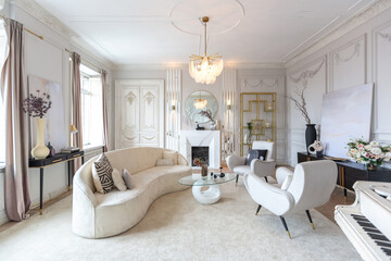 rich luxurious interior of a cozy room with modern stylish furniture nd grand piano, decorated with baroque columns and stucco on the walls