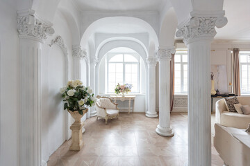 rich luxurious interior of a cozy room with modern stylish furniture nd grand piano, decorated with baroque columns and stucco on the walls