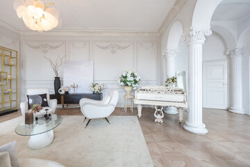 Fototapeta na wymiar rich luxurious interior of a cozy room with modern stylish furniture nd grand piano, decorated with baroque columns and stucco on the walls