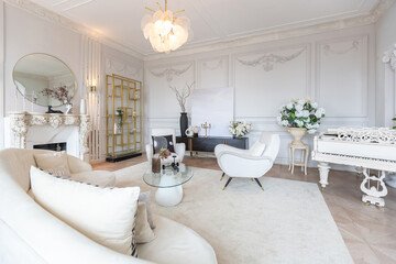 rich luxurious interior of a cozy room with modern stylish furniture nd grand piano, decorated with baroque columns and stucco on the walls
