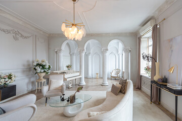 rich luxurious interior of a cozy room with modern stylish furniture nd grand piano, decorated with baroque columns and stucco on the walls