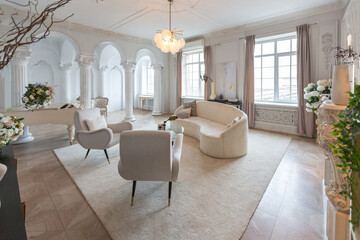rich luxurious interior of a cozy room with modern stylish furniture nd grand piano, decorated with baroque columns and stucco on the walls