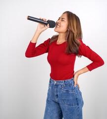 Young asian woman in red long sleeve t-shirt singing with microphone.