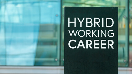 Hybrid Working Career on a sign outside a modern glass office building 