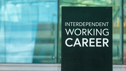 Interdependent Working Career on a sign outside a modern glass office building	
