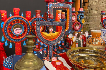 Antiques on flea market - wooden candlesticks, vintage dishes, ceramic vases and other vintage things. Collectibles memorabilia and garage sale concept. Selective focus