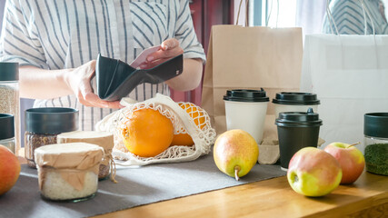 Food delivery home.Contactless delivery service.Online order and payment.Store services in food delivery in quarantine covid.Girl in the kitchen arranges food Zero waste