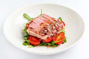 tuna fillet with salad on white plate