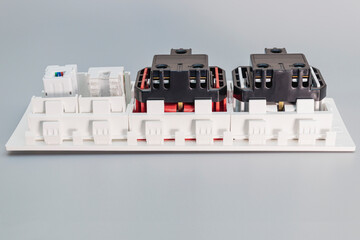 A block of electrical outlets and a network outlet on a gray background. Home electrician....